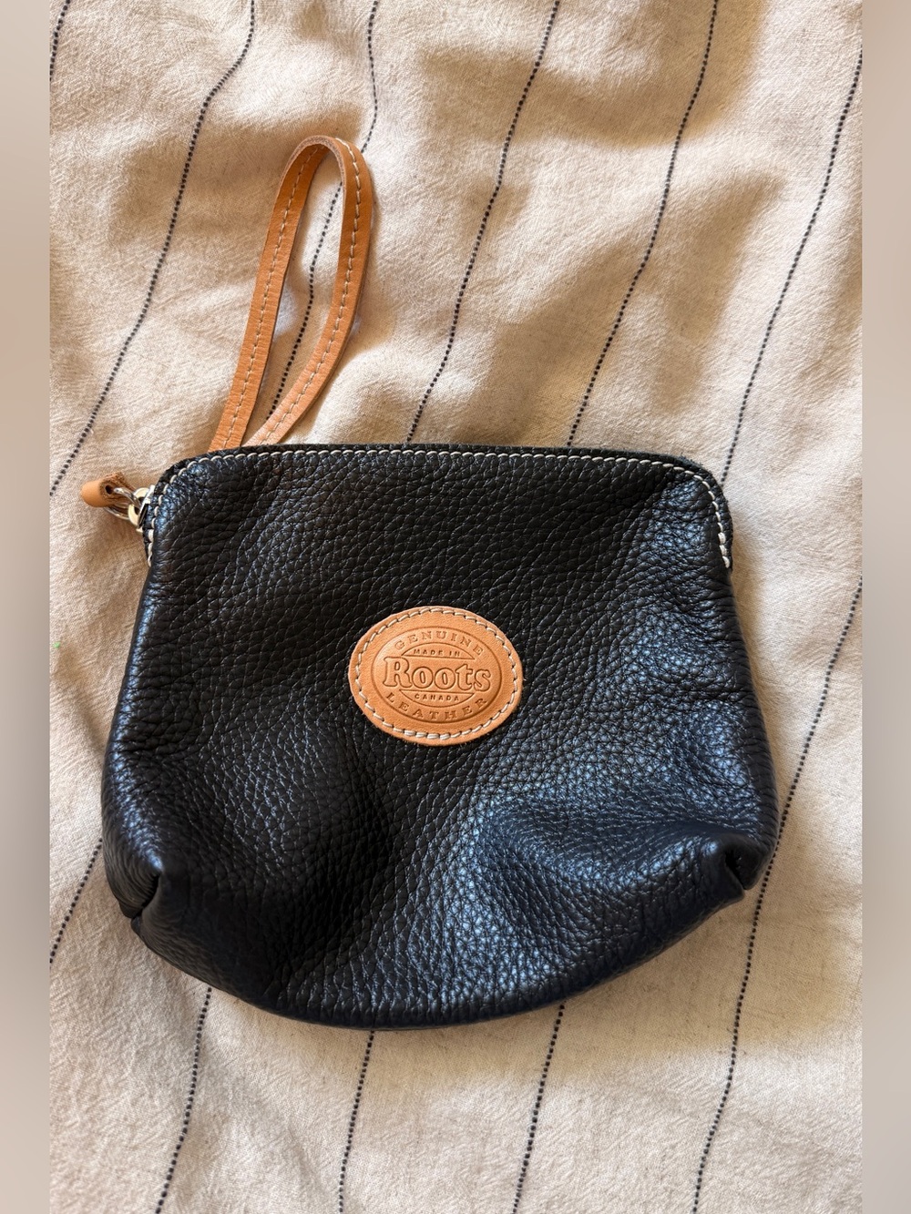 Roots Black 100% Pebbled Leather Wristlet with Tan Logo Patch